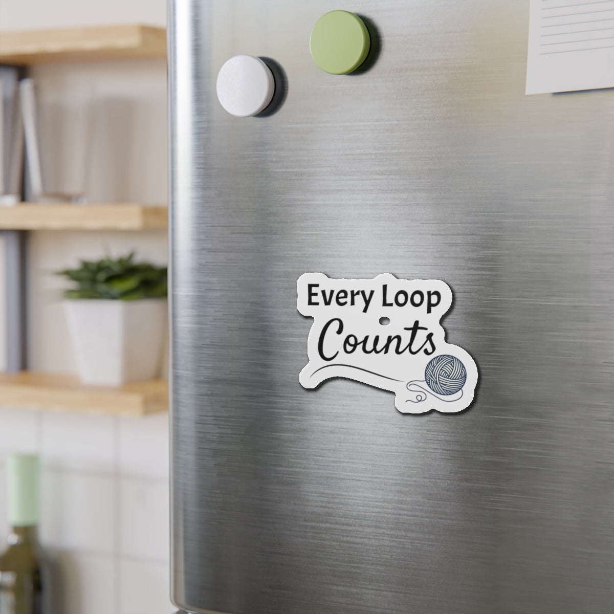 Fridge magnet with 'Every Loop Counts' text on a metallic surface