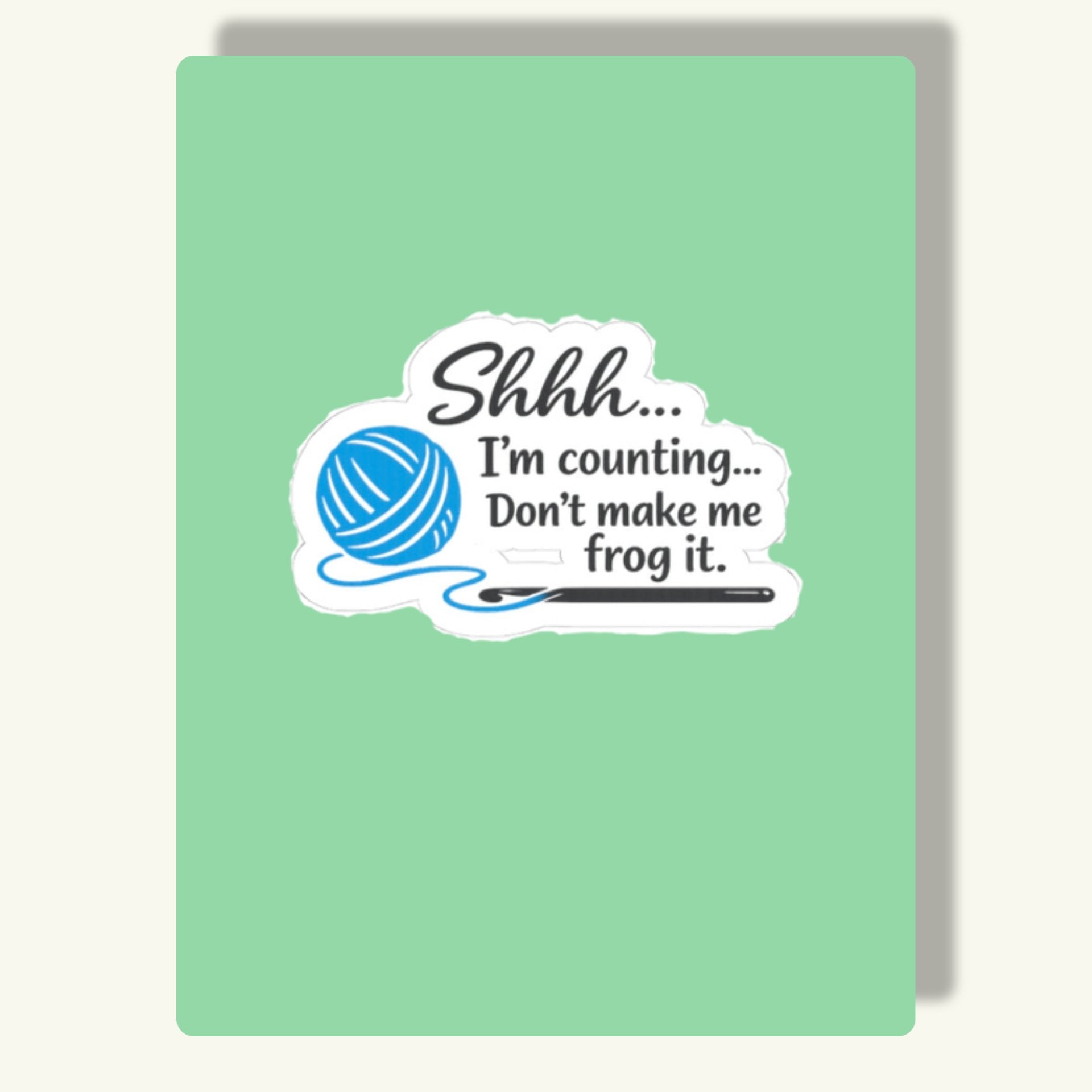 Die-cut kiss-cut sticker with a blue yarn ball and crochet hook graphic and the text 'Shhh... I'm counting... Don't make me frog it.'"