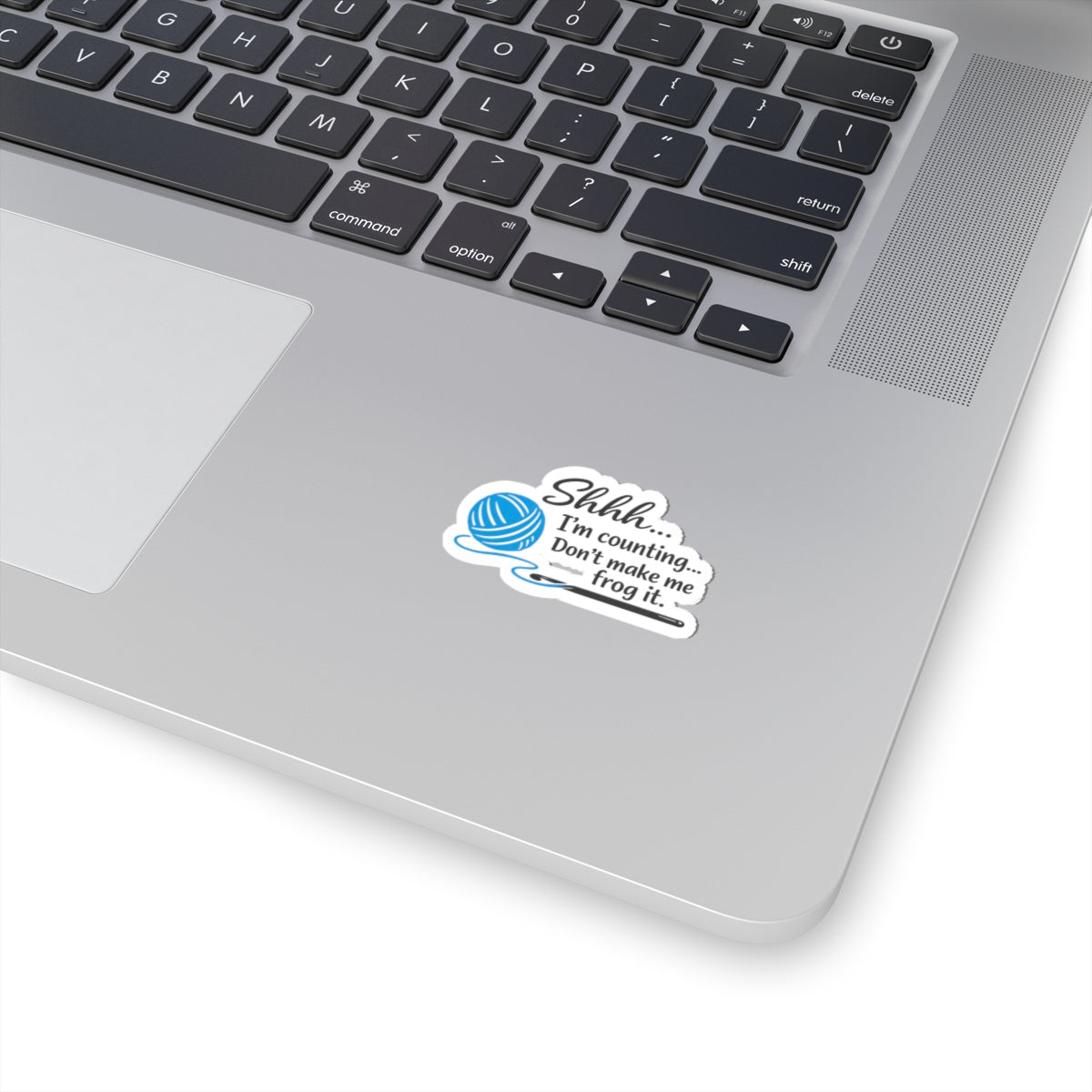 Die-cut kiss-cut sticker with a blue yarn ball and crochet hook graphic and the text 'Shhh... I'm counting... Don't make me frog it.'"
